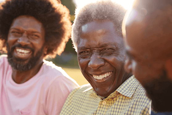 Three black men smiling and laughing